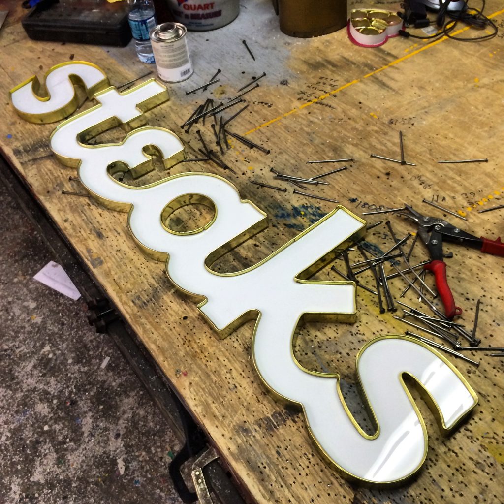 Dimensional letter Steaks sign in workshop.